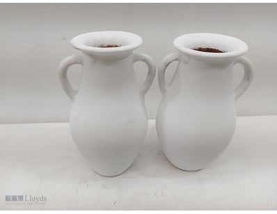 Pair of white ceramic two-handled urns with classi...