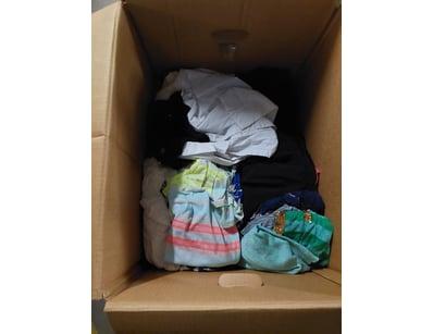 Carton box containing assorted clothing items incl...