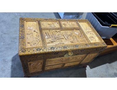 Ornate Asian carved wooden trunk featuring intrica...