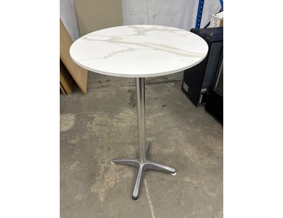 Modern round bistro table featuring a white marble...