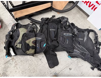 Collection of scuba diving equipment featuring mul...
