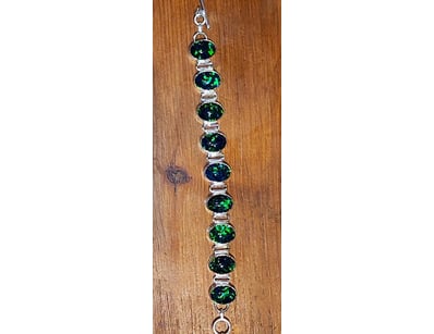 136 TCW OPAL TRIPLET AND SILVER BRACELET.    

Dim...