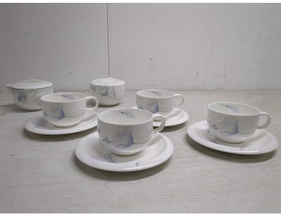 Elegant porcelain plas tea set featuring botanical...