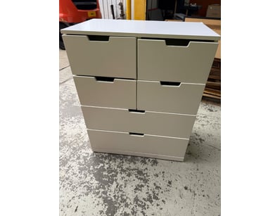 Cream/beige multi-drawer storage chest featuring a...
