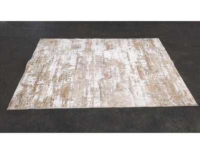 Distressed vintage-style area rug featuring a worn...