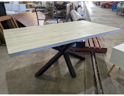 Modern dining table featuring a light ash wood-gra...