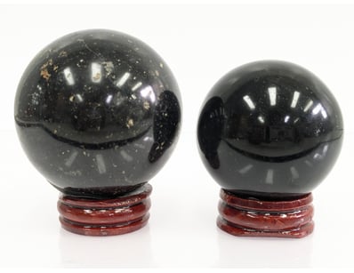 PAIR OF POLISHED BLACK TOURMALINE SPHERES WITH WOO...