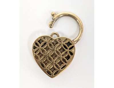 Exquisite 9K gold antique locket featuring a heart...