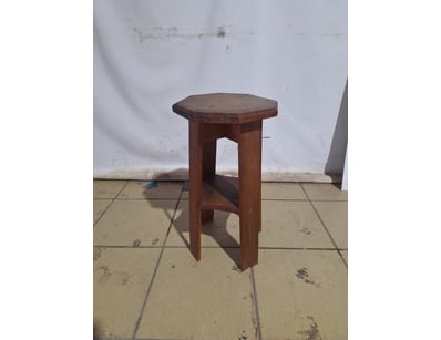 Wooden stool featuring an octagonal top with bevel...