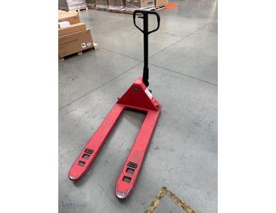 Red manual pallet jack with 2500kg capacity. Featu...