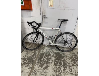 De Rosa road bike featuring a white frame with bla...