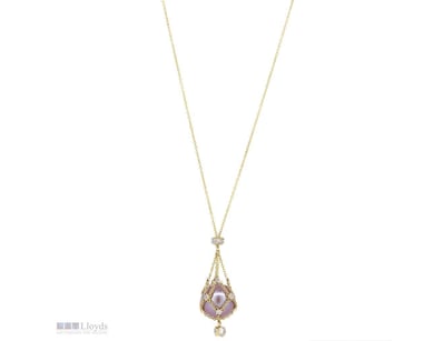 THE DESIGN FEATURES, ONE NEAR ROUND, PINK WITH SIL...