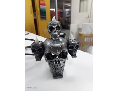 Lot comprising decorative skull candle holders and...