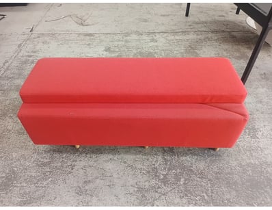Red upholstered storage bench featuring a dual-tie...