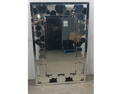 Decorative wall mirror featuring a contemporary de...