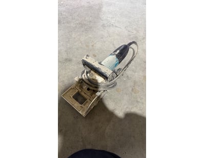 Vintage corded power tool featuring a black plasti...