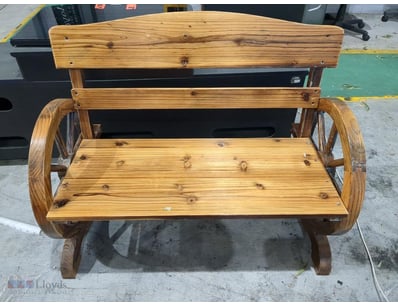 Rustic wooden wagon bench featuring a charming cou...
