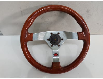 Vintage sports steering wheel featuring a rich bur...