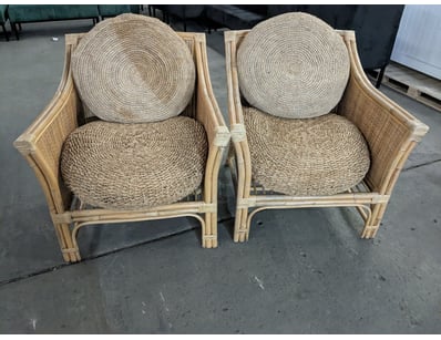 Rattan and woven natural fibre armchairs featuring...