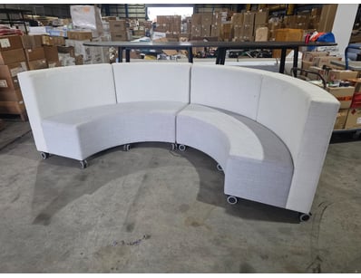 Modern curved modular seating unit featuring a lig...