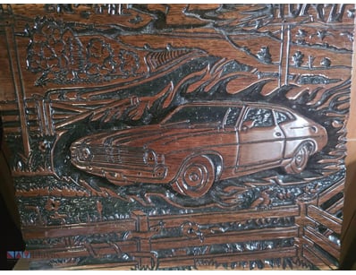 Handcrafted wooden carving featuring a Ford XA Fal...
