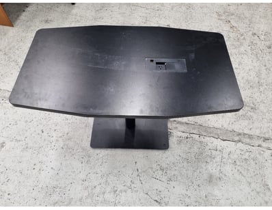 Modern black pedestal dining table featuring a cur...