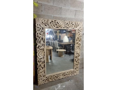 Ornate carved wooden mirror featuring an elaborate...