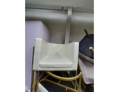 Contemporary cream upholstered armchair featuring ...