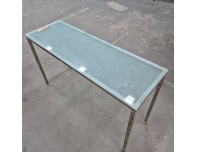 Modern console table featuring a  tempered glass t...