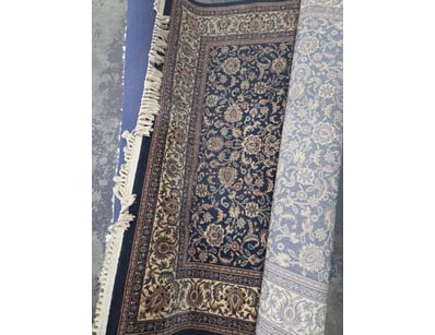 rug featuring a traditional Persian-inspired desig...