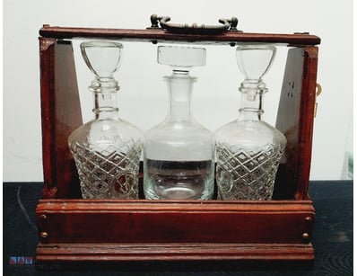 VICTORIAN MAHOGANY TANTALUS WITH THREE CUT GLASS D...