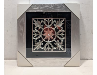 Decorative wall art piece featuring an ornamental ...