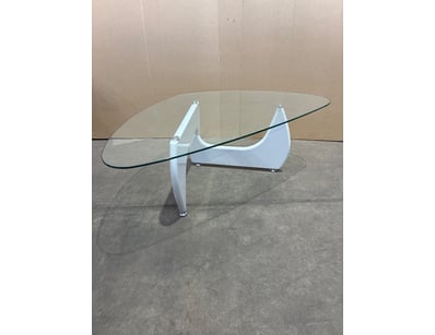 Modern glass coffee table featuring an elegant cur...