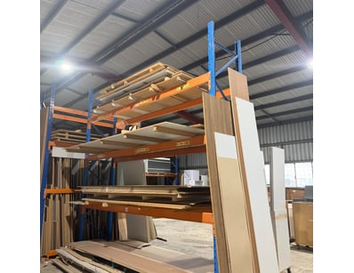 Heavy-duty pallet racking system featuring 2 blue ...
