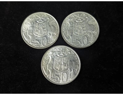 THREE SILVER 1966 ROUND FIFTY CENT COINS

Condit...