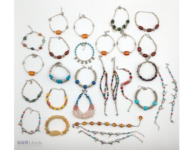 EXTENSIVE COLLECTION OF SILVER-TONED BEADED BRACEL...
