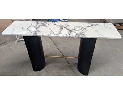 Modern console table featuring a white marble-effe...