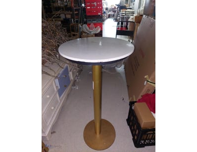 Modern round pedestal table featuring a white marb...