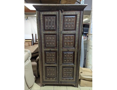Ornate two-door cabinet featuring exceptional carv...