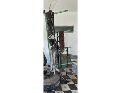 Assorted horse equipment on homemade metal tyre ra...