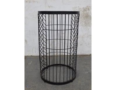 Modern cylindrical side table featuring a striking...