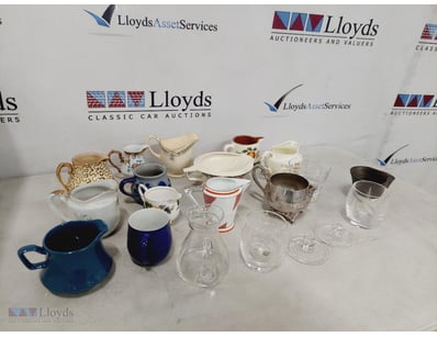 ASSORTED CERAMICS AND GLASSWARE JUGS AND TEAPOTS.
...