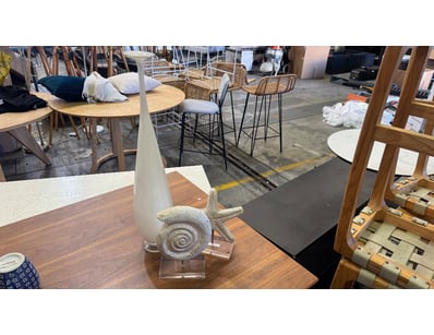 Coastal-inspired decorative sculpture featuring a ...