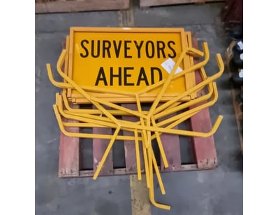 Lot of yellow metal "SURVEYORS AHEAD" warning sign...
