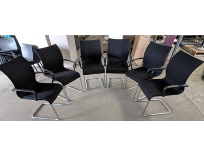Modern cantilever office chairs featuring black me...