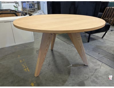 Modern round dining table featuring a natural ligh...