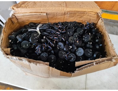 Assorted box of black AC power cables