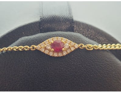 18K YELLOW GOLD RUBY AND DIAMOND BRACELET

An El...