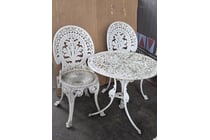 5304 · White cast metal bistro set features an intricate