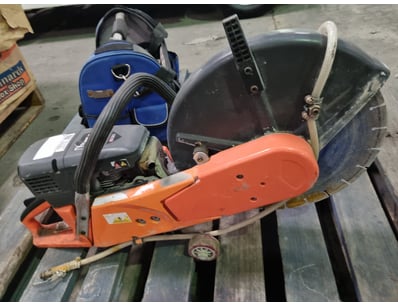 Petrol-powered chainsaw with orange and black fini...
